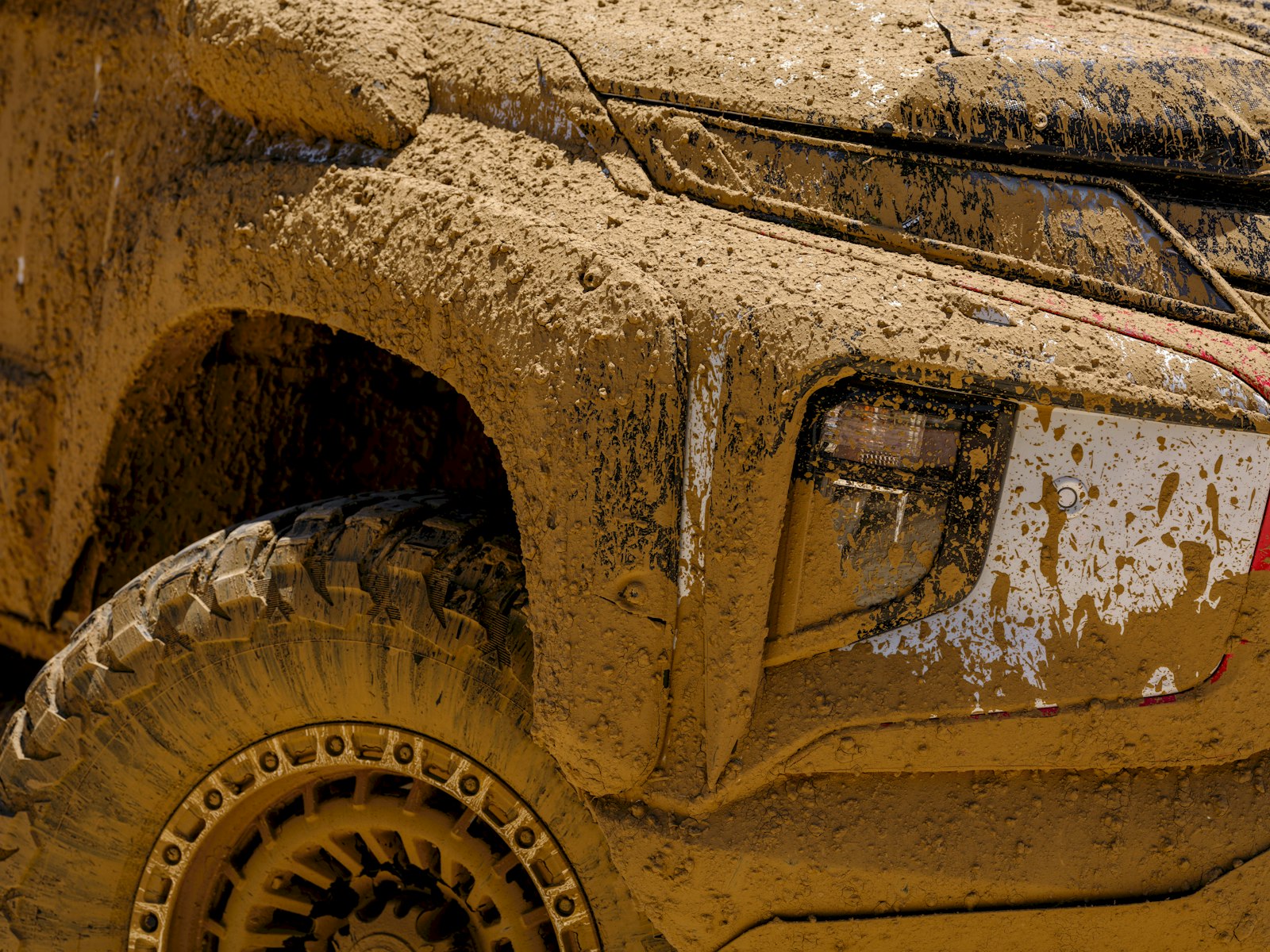 Close-up of a mud-covered off-road vehicle tire