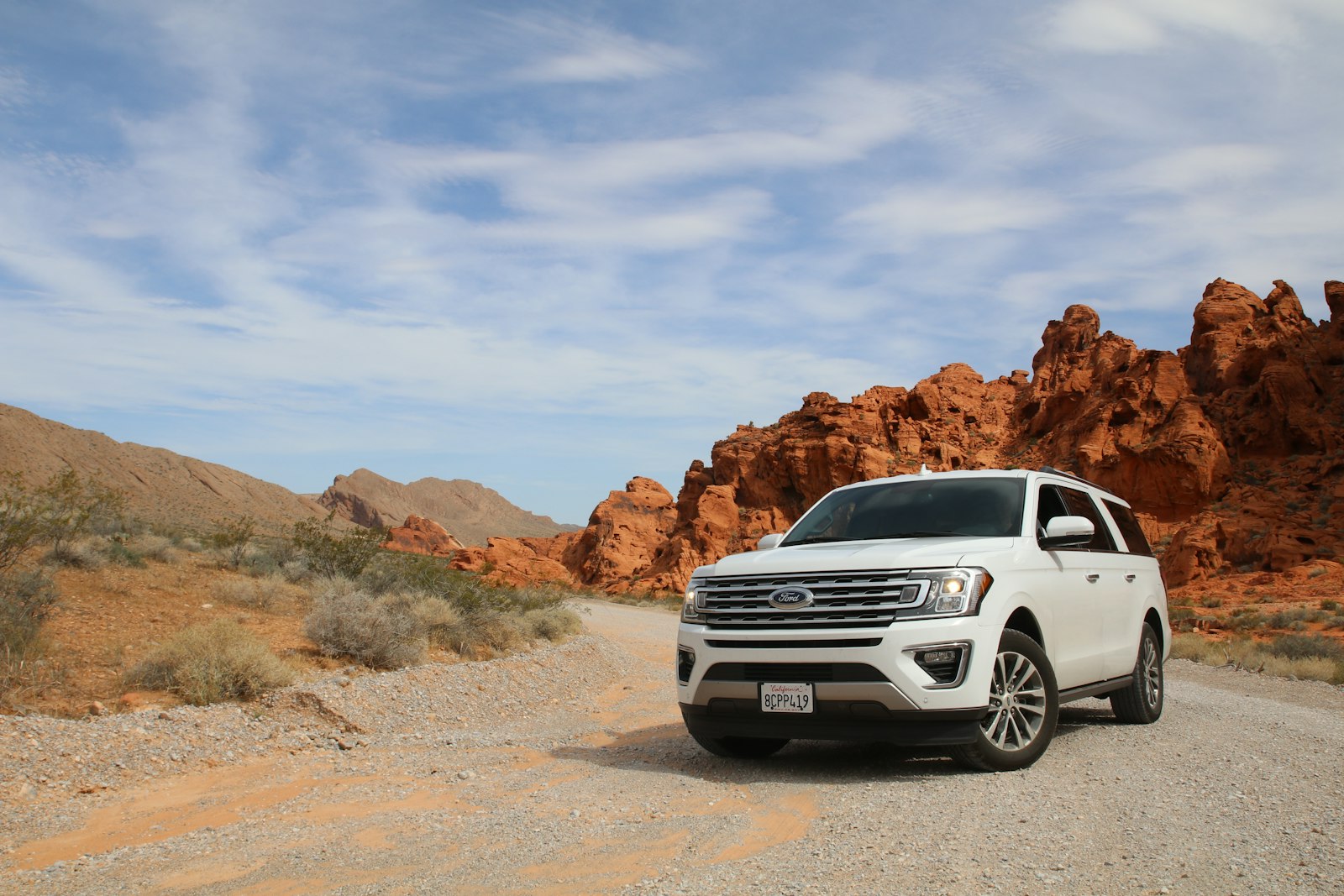 Off-road 4x4 vehicle driving on rugged dirt trail terrain
